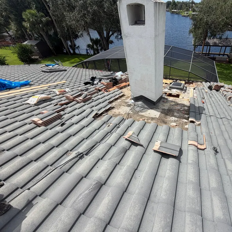 Tile roof in Lake County, FL opened up around a stucco chimney by Pro Specialty Services to find a leak